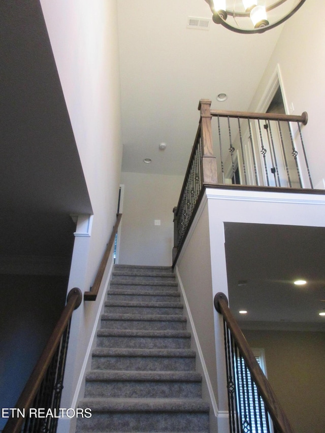stairway featuring a chandelier, recessed lighting, visible vents, and baseboards