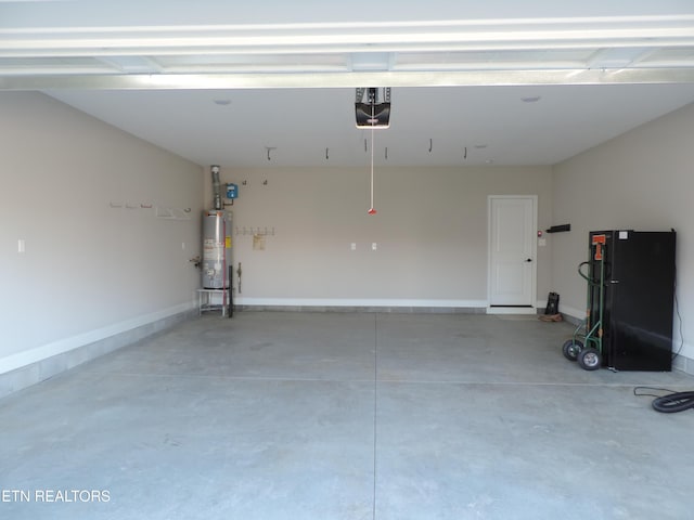 garage featuring a garage door opener, baseboards, and gas water heater
