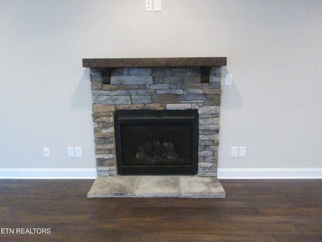 room details featuring wood finished floors, a fireplace, and baseboards