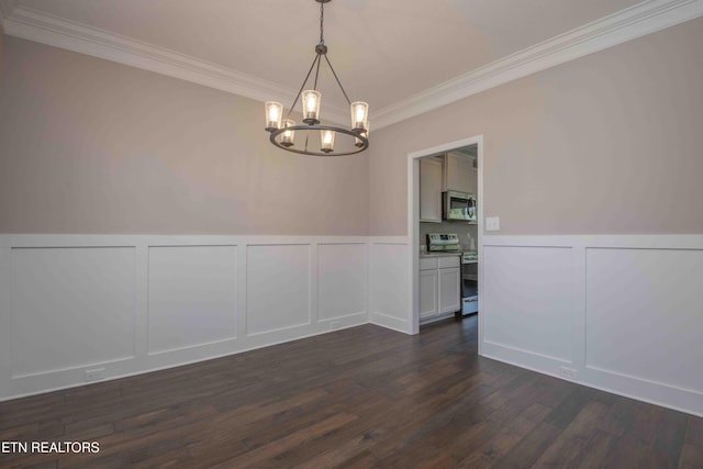 unfurnished dining area with a notable chandelier, dark wood-style flooring, ornamental molding, wainscoting, and a decorative wall