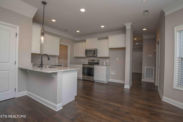 kitchen featuring ornamental molding, a peninsula, white cabinets, visible vents, and stainless steel appliances