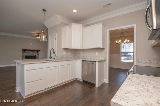 kitchen featuring ornamental molding, visible vents, stainless steel appliances, ceiling fan with notable chandelier, and a sink