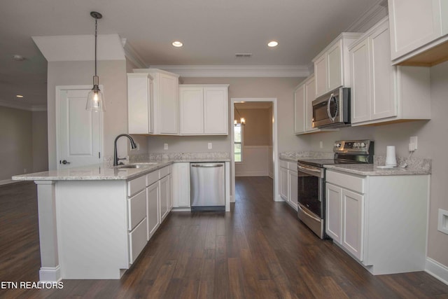 kitchen featuring light stone counters, a peninsula, dark wood finished floors, stainless steel appliances, and a sink