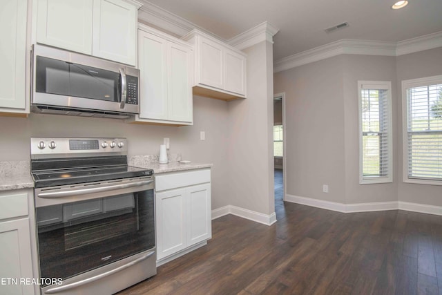 kitchen featuring dark wood finished floors, white cabinetry, ornamental molding, visible vents, and stainless steel appliances