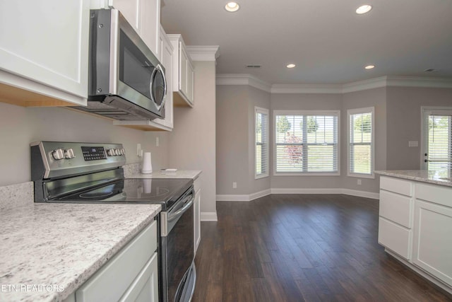 kitchen with white cabinets, dark wood-type flooring, baseboards, and appliances with stainless steel finishes
