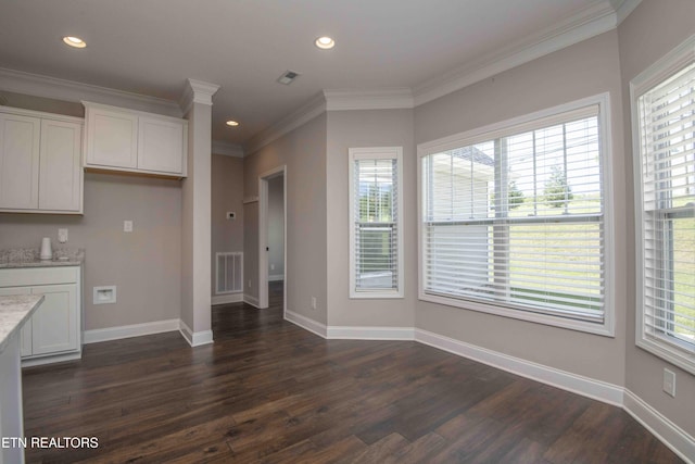 kitchen featuring dark wood-type flooring, white cabinets, and visible vents
