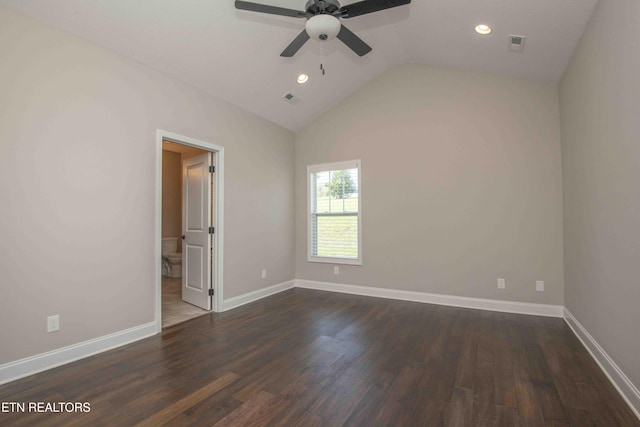 unfurnished bedroom featuring dark wood-style flooring, baseboards, lofted ceiling, and visible vents