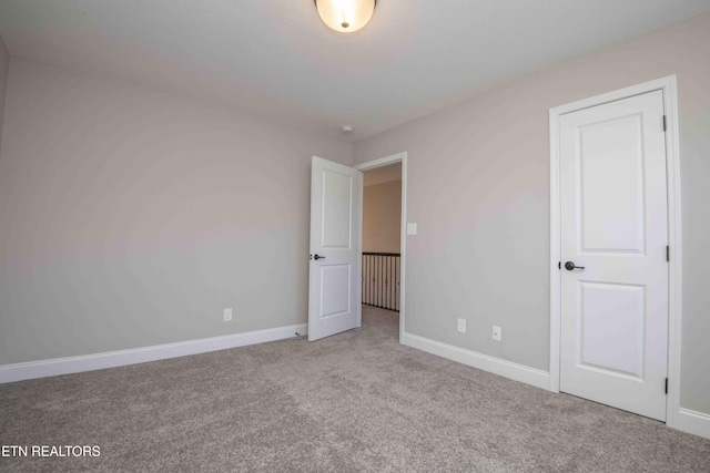 unfurnished bedroom with baseboards and carpet floors