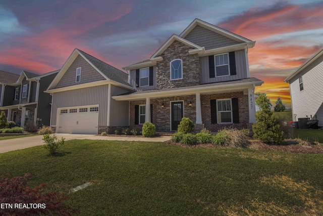 craftsman inspired home with concrete driveway, stone siding, a front lawn, a porch, and a garage