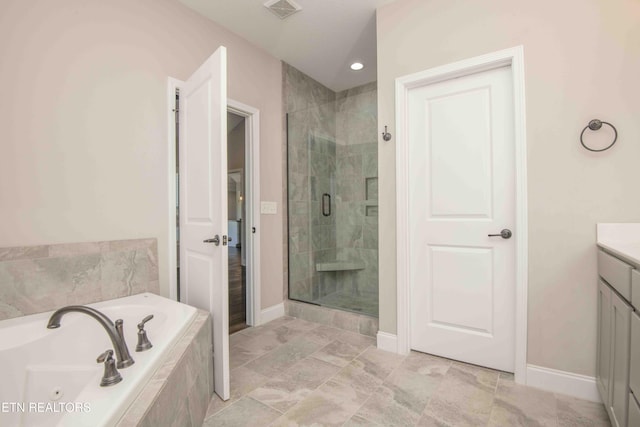 bathroom with a jetted tub, vanity, baseboards, a stall shower, and visible vents