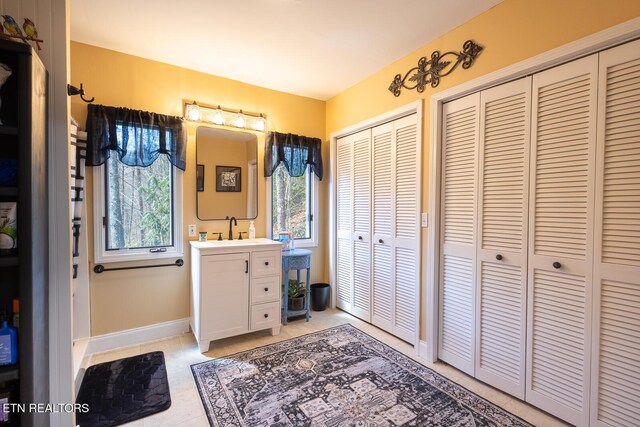 1027 N Highland Dr, Gatlinburg, TN 37738 - bathroom with tile patterned flooring, vanity, baseboards, and a closet