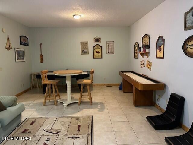 interior space with light tile patterned floors and baseboards
