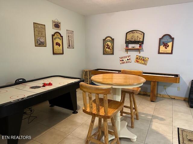 game room with light tile patterned floors