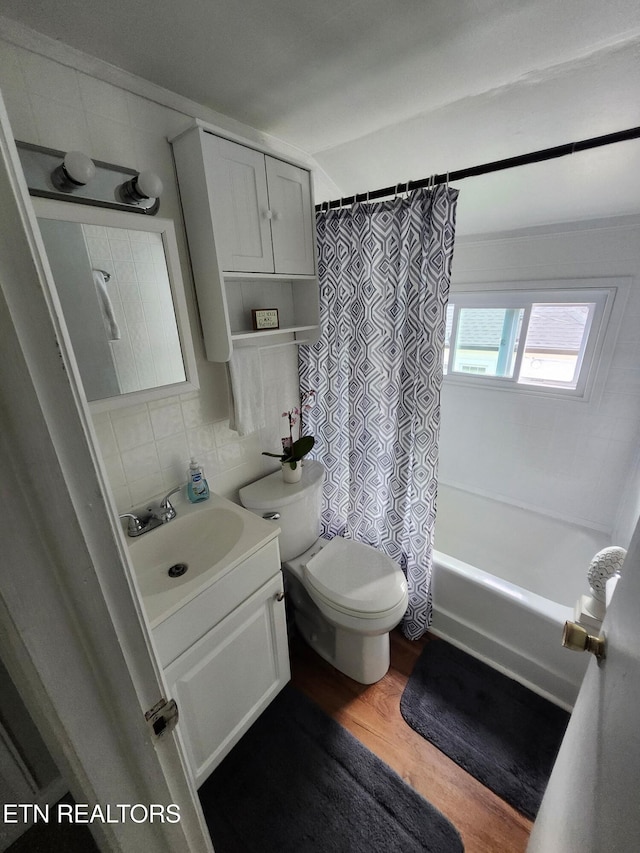 3009 Sanders Dr, Knoxville, TN 37918 - bathroom featuring vanity, wood finished floors, shower / bath combination with curtain, toilet, and tasteful backsplash