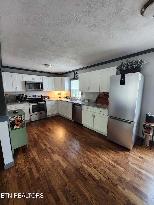 3009 Sanders Dr, Knoxville, TN 37918 - kitchen with stainless steel appliances, a textured ceiling, and dark wood-type flooring