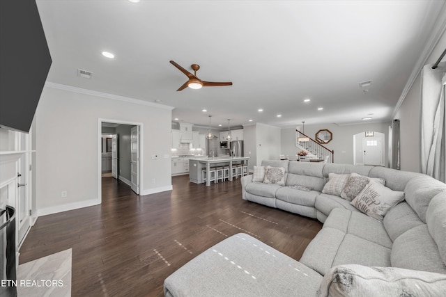 living area featuring visible vents, a ceiling fan, stairs, and dark wood-type flooring