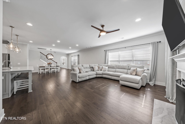 living area featuring recessed lighting, ornamental molding, dark wood-style flooring, and ceiling fan
