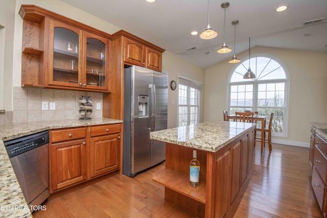 107 Sunny St, Sharps Chapel, TN 37866 - kitchen featuring appliances with stainless steel finishes, open shelves, light wood-type flooring, lofted ceiling, and brown cabinets