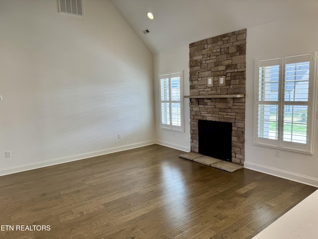 unfurnished living room featuring baseboards, a fireplace, visible vents, and dark wood finished floors