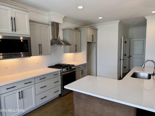 kitchen with a sink, tasteful backsplash, dark wood-style floors, stainless steel appliances, and wall chimney range hood