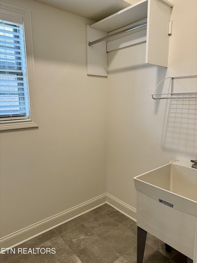 walk in closet with a sink