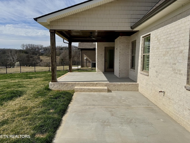 view of patio / terrace with a ceiling fan and fence