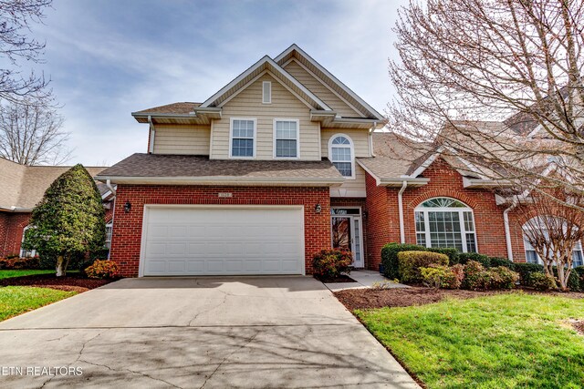 1120 Treymour Way, Knoxville, TN 37922 - traditional-style house with brick siding, concrete driveway, a front yard, roof with shingles, and a garage