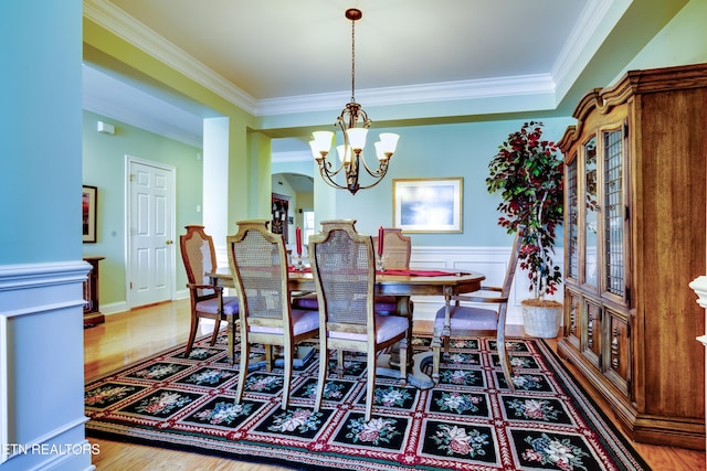 1120 Treymour Way, Knoxville, TN 37922 - dining space featuring a wainscoted wall, wood finished floors, a chandelier, and crown molding