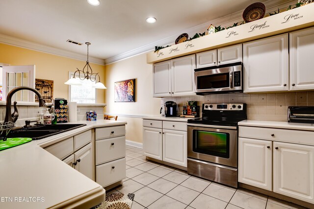 1120 Treymour Way, Knoxville, TN 37922 - kitchen featuring a sink, stainless steel appliances, crown molding, light countertops, and decorative backsplash