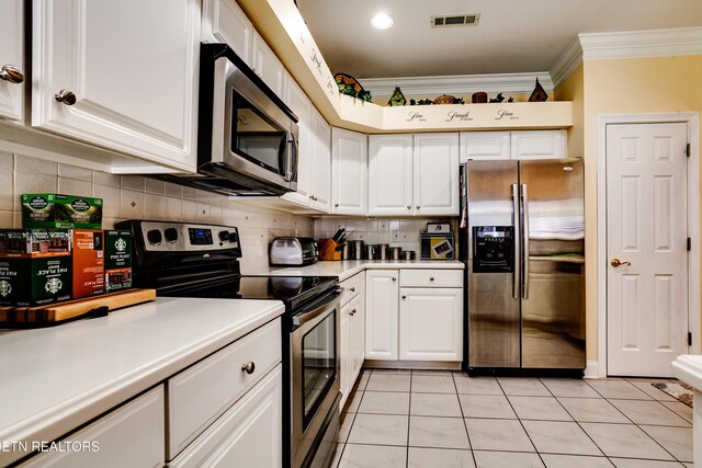 1120 Treymour Way, Knoxville, TN 37922 - kitchen with visible vents, ornamental molding, stainless steel appliances, white cabinetry, and tasteful backsplash