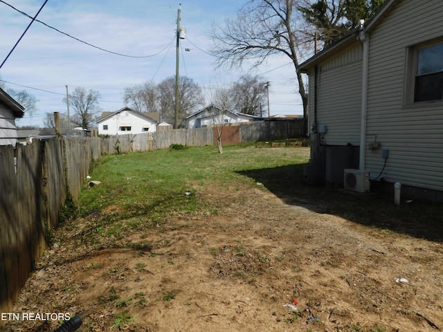 view of yard featuring fence and ac unit