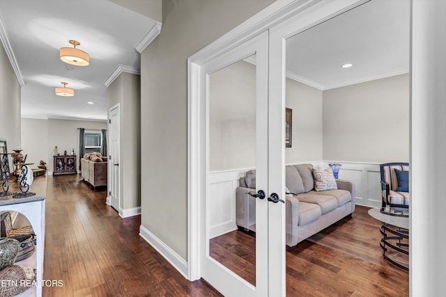 corridor with a wainscoted wall, french doors, hardwood / wood-style floors, and ornamental molding