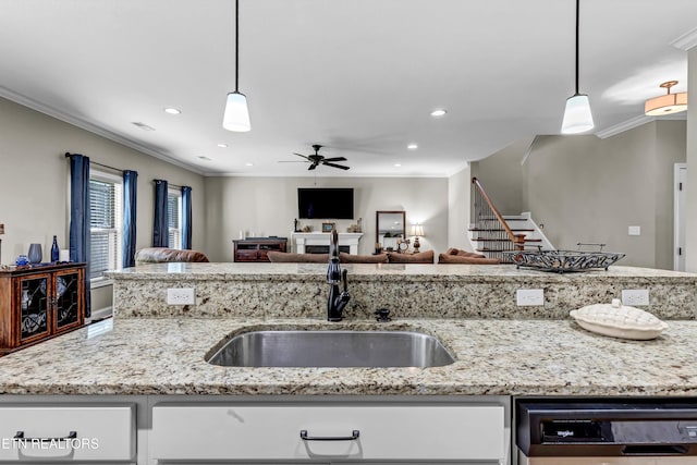 kitchen featuring dishwashing machine, white cabinets, crown molding, and open floor plan