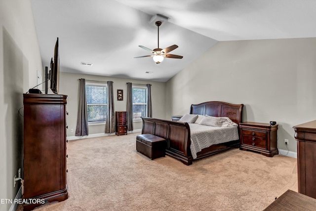 carpeted bedroom featuring visible vents, lofted ceiling, baseboards, and ceiling fan