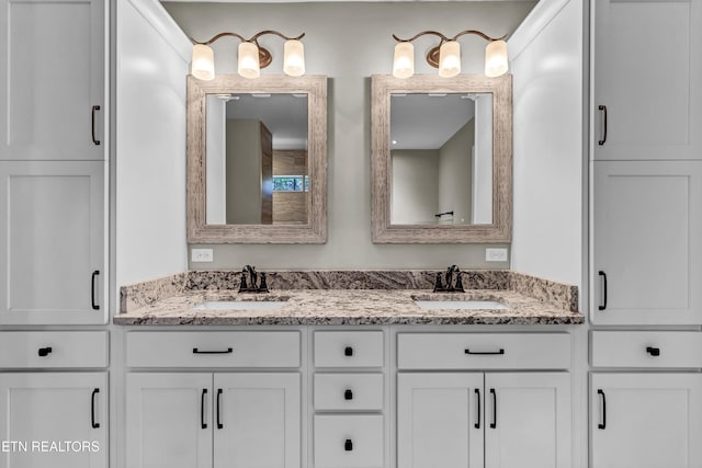 full bath featuring double vanity and a sink