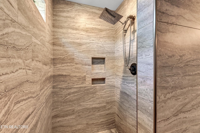 bathroom with tiled shower