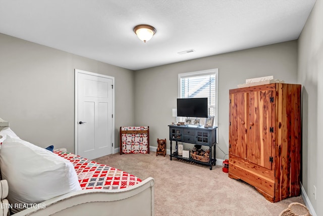 carpeted bedroom featuring visible vents and baseboards