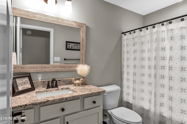 bathroom featuring vanity, toilet, and a shower with curtain