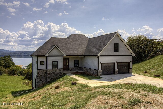 736 Cow Poke Ln, Rutledge, TN 37861 - view of front of home featuring a front yard, an attached garage, driveway, and a water view