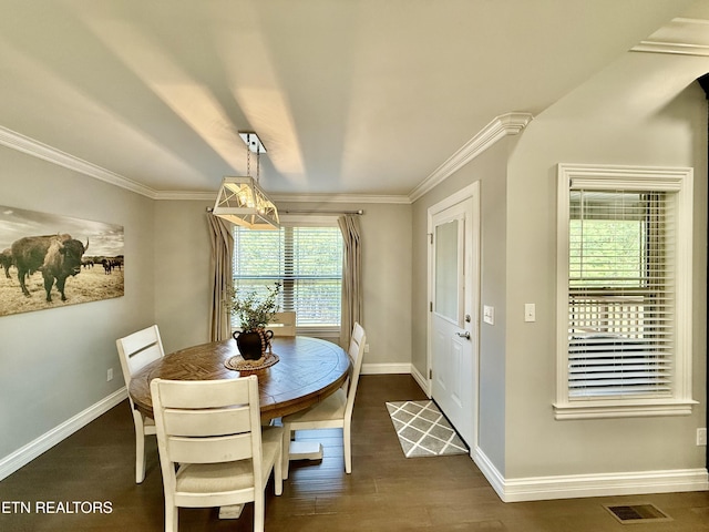 dining area with crown molding, dark wood-style floors, visible vents, and baseboards