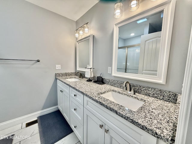 full bathroom featuring a sink, visible vents, baseboards, and marble finish floor