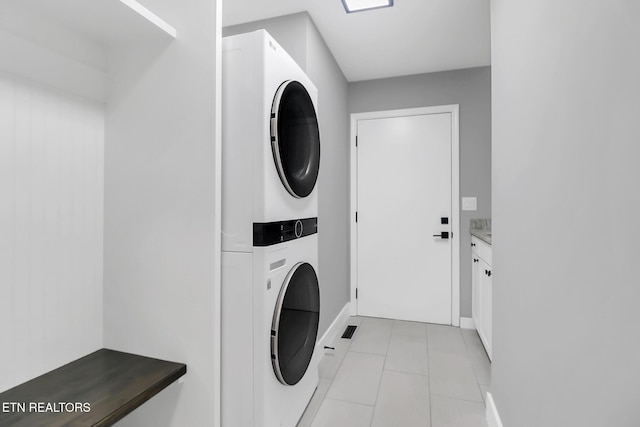 123 Lakeview Dr, Crossville, TN 38558 - clothes washing area featuring light tile patterned floors and stacked washer and clothes dryer