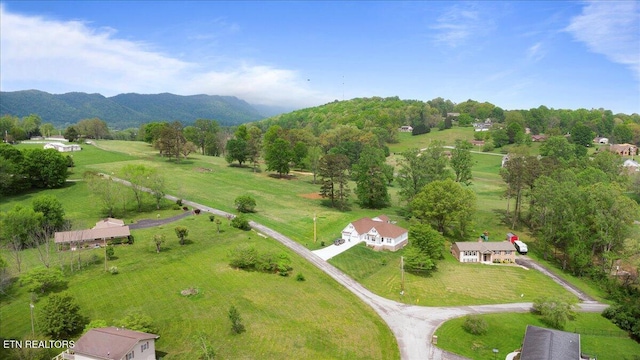 birds eye view of property with a mountain view and a rural view