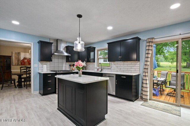 416 Summitt Dr, Lafollette, TN 37766 - kitchen featuring wall chimney exhaust hood, stainless steel dishwasher, dark cabinetry, light countertops, and light wood finished floors