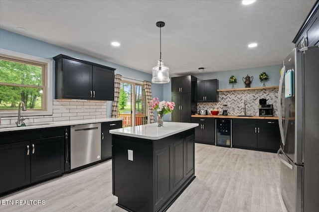 416 Summitt Dr, Lafollette, TN 37766 - kitchen featuring stainless steel appliances, a sink, wine cooler, dark cabinets, and light countertops