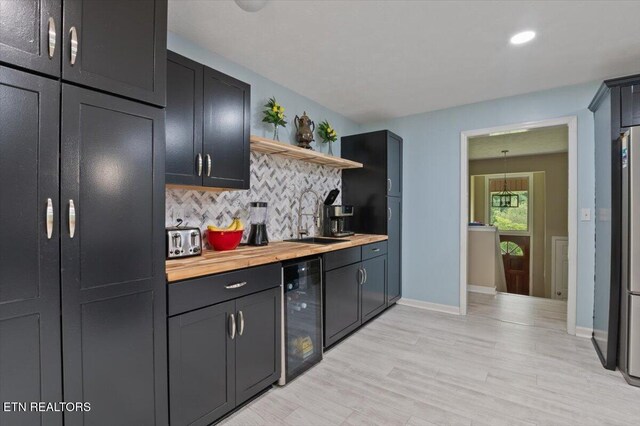 416 Summitt Dr, Lafollette, TN 37766 - kitchen featuring a sink, beverage cooler, open shelves, backsplash, and wooden counters