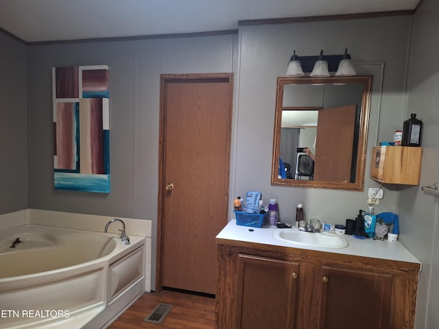 156 Croft Rd, Tellico Plains, TN 37385 - full bathroom with vanity, a garden tub, wood finished floors, and visible vents