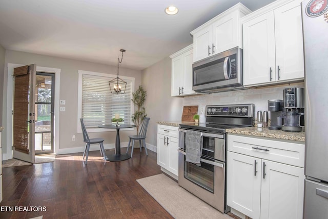 1312 Fox Ridge Dr, Powell, TN 37849 - kitchen with backsplash, dark wood-style floors, stainless steel appliances, white cabinets, and baseboards