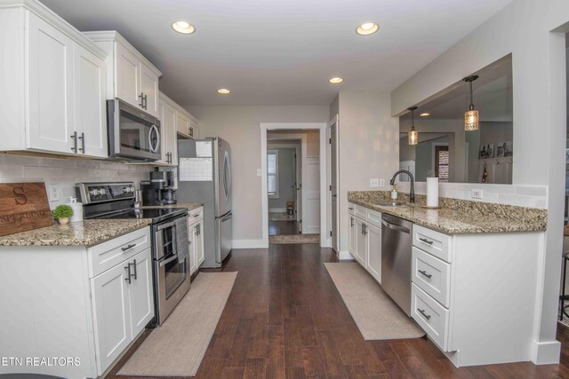 1312 Fox Ridge Dr, Powell, TN 37849 - kitchen with dark wood-style flooring, a sink, stainless steel appliances, white cabinets, and backsplash