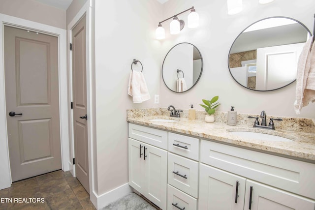 1312 Fox Ridge Dr, Powell, TN 37849 - bathroom featuring double vanity, baseboards, and a sink